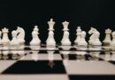 white chess piece on top of chess board